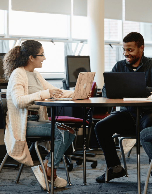 Two students meeting with an advisor in the Learning Commons